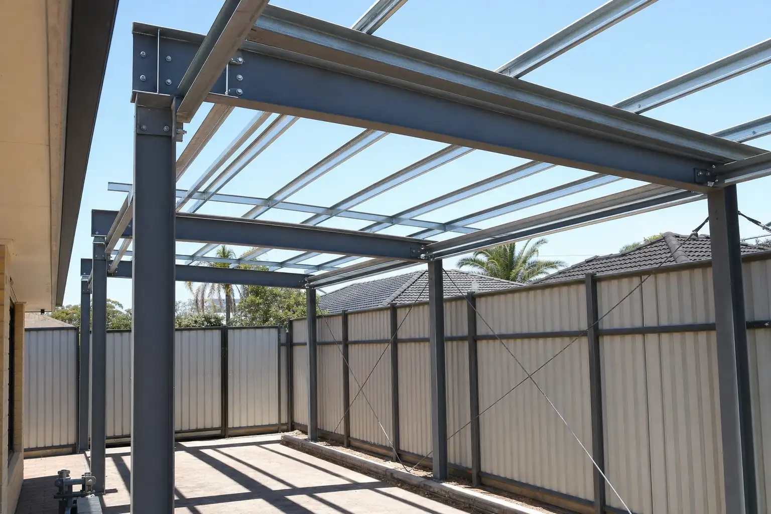 Perth Carport Co tradies installing a Colorbond carport ridge beam in Perth